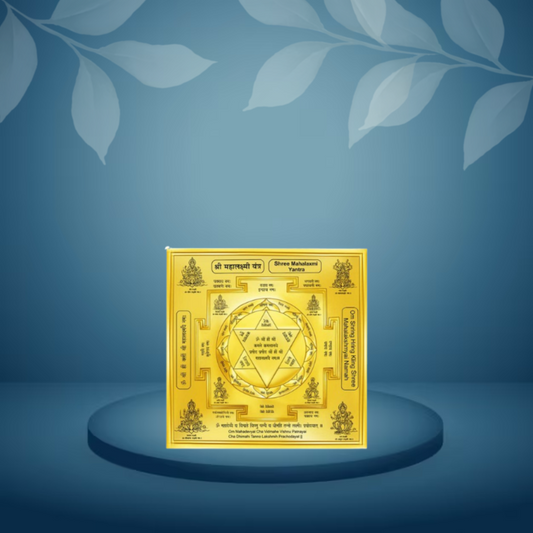 Gold-colored decorative item with intricate designs on a blue background